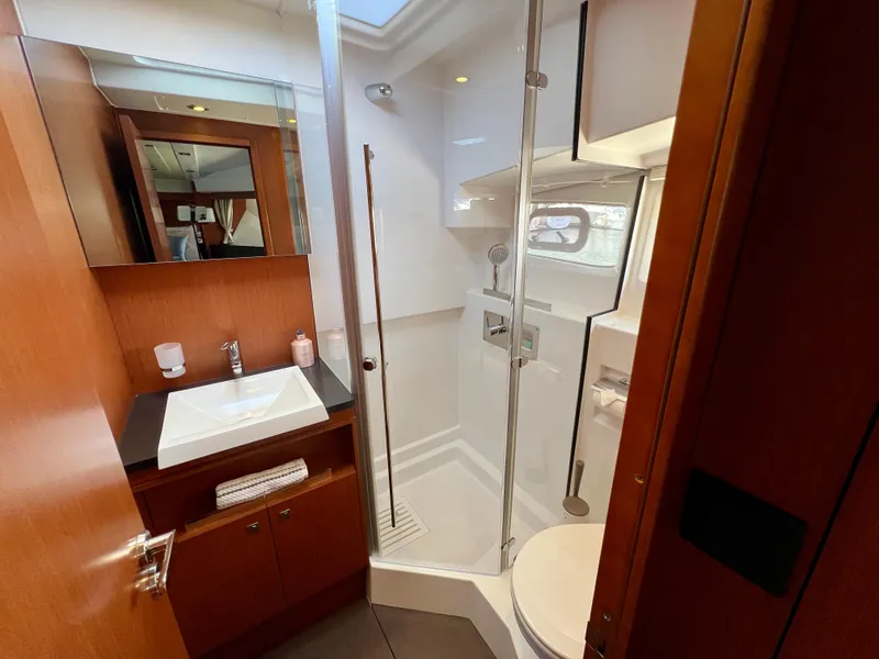 Slide: The Image of Luxurious bathroom in 2017 Jeanneau Velasco 43 yacht with modern fixtures and wood accents. - 15