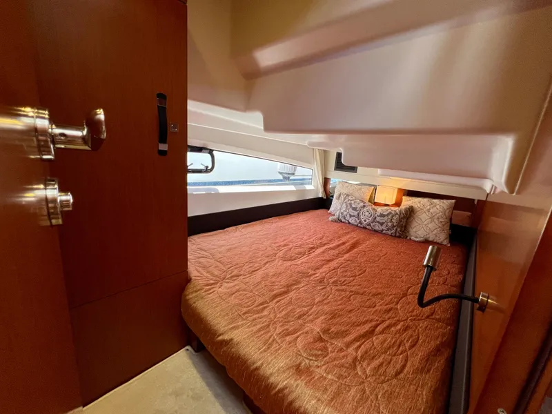 Slide: The Image of Cozy cabin interior of 2017 Jeanneau Velasco 43 with a comfortable bed and elegant decor. - 16