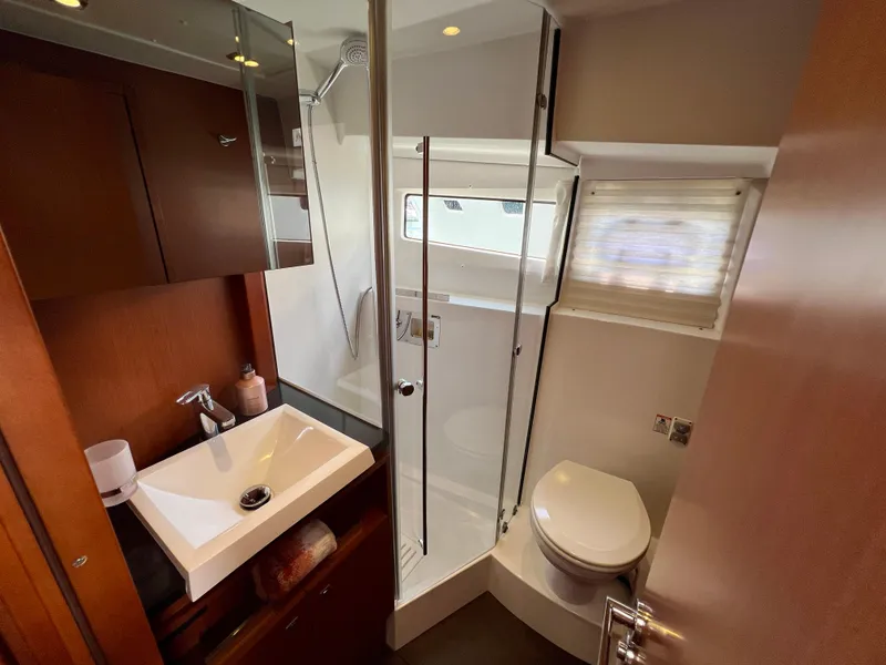 Slide: The Image of Luxurious bathroom in 2017 Jeanneau Velasco 43 yacht with modern fixtures and glass shower. - 17