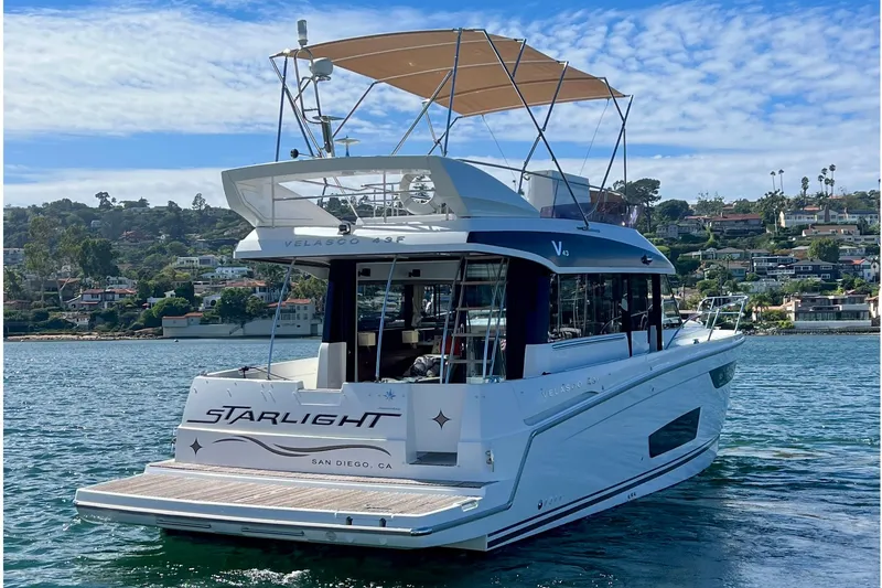 Slide: The Image of 2017 Jeanneau Velasco 43 yacht on water, San Diego backdrop, clear sky. - 2
