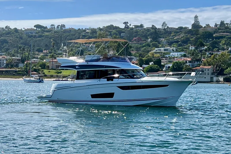 Slide: The Image of 2017 Jeanneau Velasco 43 yacht cruising on scenic coastal waters. - 3