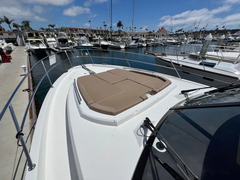 Slide: The Image of 2017 Jeanneau Velasco 43 yacht docked at marina, featuring spacious sunbathing area. - 33