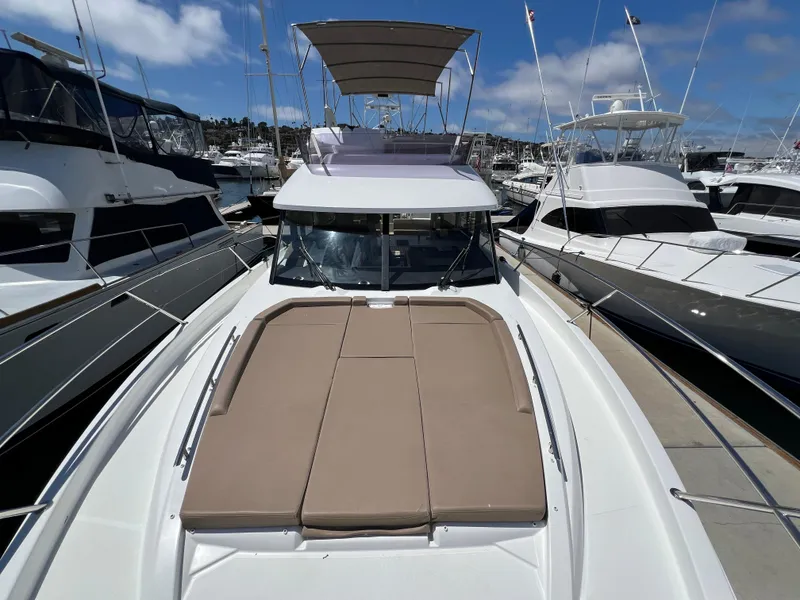 Slide: The Image of 2017 Jeanneau Velasco 43 yacht docked at marina, featuring spacious sunbathing area. - 34