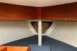 Slide: The Image of Interior view of a 1999 Alerion 26 sailboat, featuring wooden accents and a cozy cabin space. - 15