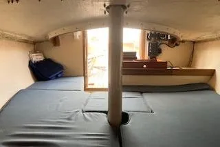 Slide: The Image of Interior cabin of a 1999 Alerion 26 sailboat with cushioned seating and navigation equipment. - 16