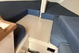 Slide: The Image of Interior cabin of a 1999 Alerion 26 sailboat with blue cushions. - 18