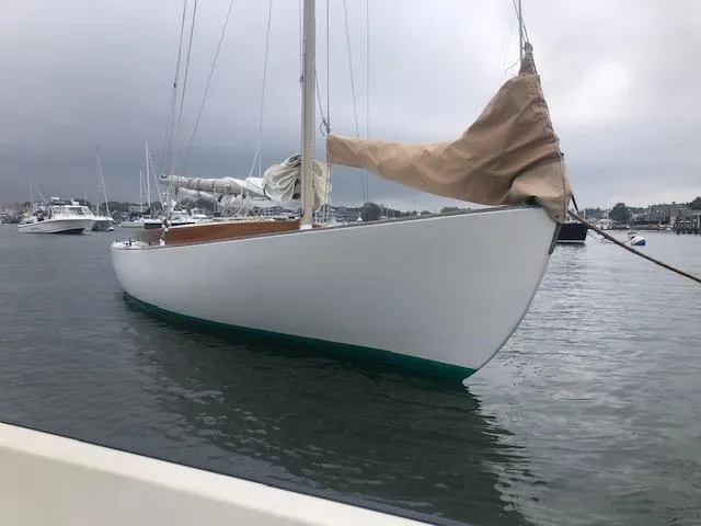 Slide: The Image of Alerion 26 sailboat from 1999 moored in a calm harbor. - 3