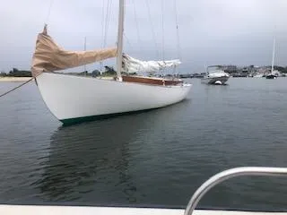 Slide: The Image of Alerion 26 sailboat from 1999 anchored in a calm harbor. - 4
