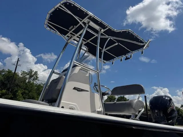 Slide: The Image of 2025 Avid 23 Mag boat with T-top under a clear blue sky. - 15