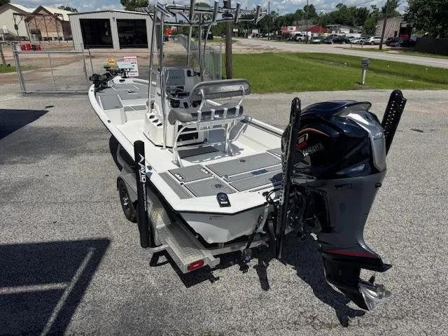 Slide: The Image of 2025 Avid 23 Mag boat with Yamaha outboard motor, parked on a trailer in a lot. - 4