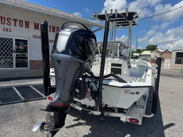 Slide: The Image of Avid 23 Mag 2025 boat with powerful outboard motor, parked outside a marine shop. - 6