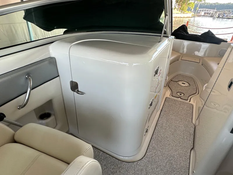 Slide: The Image of Interior of a 2010 Sea Ray 240 Sundeck boat, featuring seating and storage area. - 11