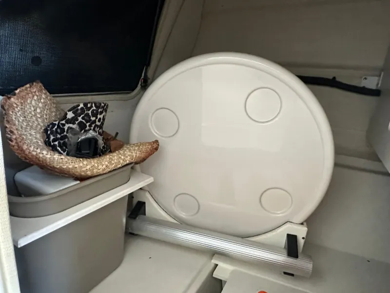 Slide: The Image of Interior of a 2010 Sea Ray 240 Sundeck with storage and accessories. - 16