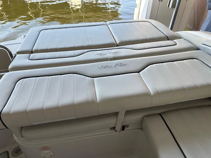 Slide: The Image of 2010 Sea Ray 240 Sundeck boat interior with white cushioned seating. - 4