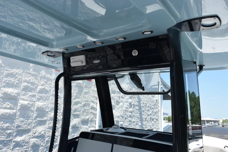 Slide: The Image of 2026 Sea Hunt Gamefish 30 Forward Seating boat console with overhead storage and lighting. - 10