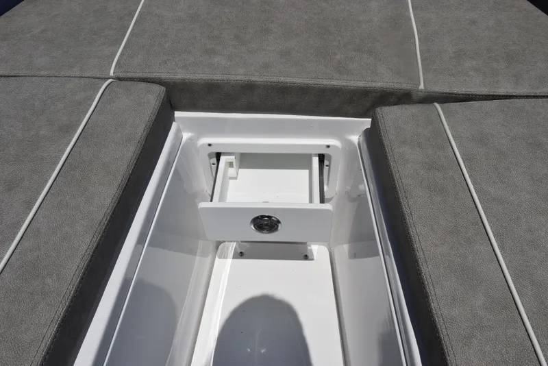 Slide: The Image of 2026 Sea Hunt Gamefish 30 Forward Seating storage compartment with gray cushioned seats. - 16