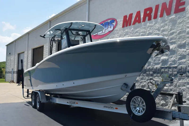 Slide: The Image of 2026 Sea Hunt Gamefish 30 Forward Seating boat on trailer outside marine dealership. - 2