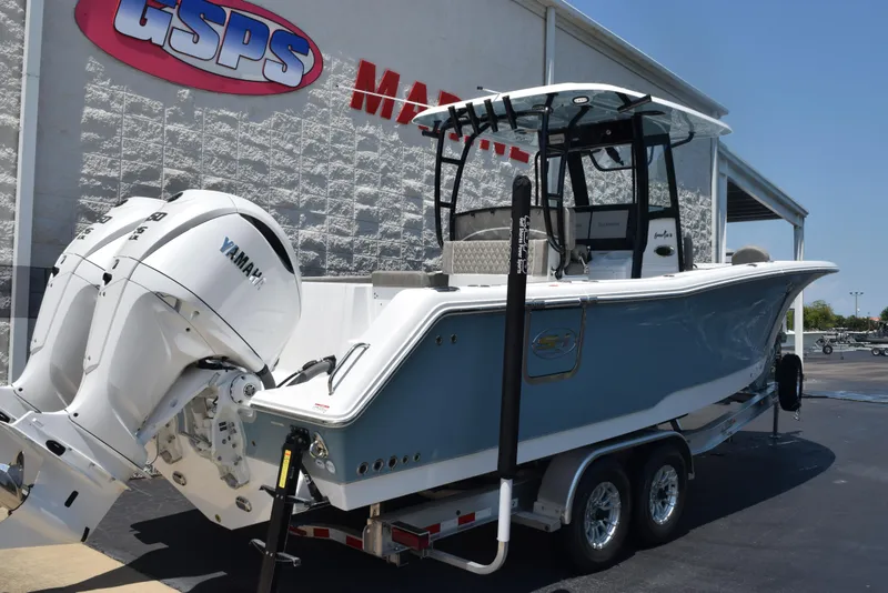 Slide: The Image of 2026 Sea Hunt Gamefish 30 boat with Yamaha engines, parked at dealership. - 4