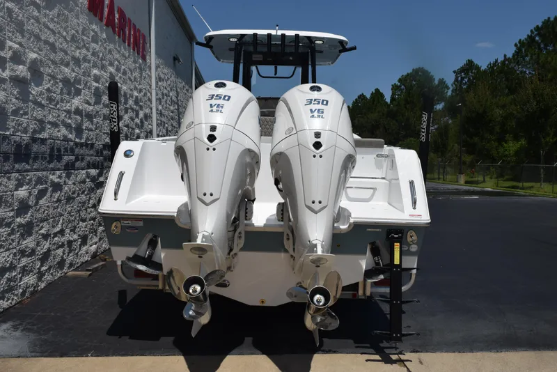 Slide: The Image of 2026 Sea Hunt Gamefish 30 with twin 350 V6 engines, parked outdoors. - 5