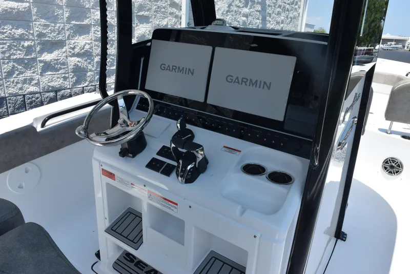 Slide: The Image of 2026 Sea Hunt Gamefish 30 helm with dual Garmin displays and modern controls. - 9