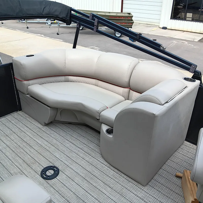 Slide: The Image of 2017 Cypress Cay Seabreeze 213 boat interior with beige seating and cup holders. - 12