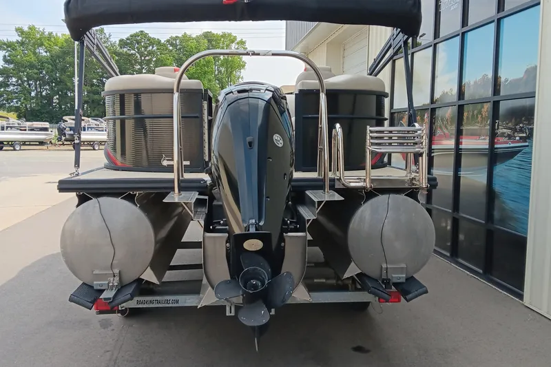 Slide: The Image of 2017 Cypress Cay Seabreeze 213 pontoon boat rear view with motor and trailer. - 2
