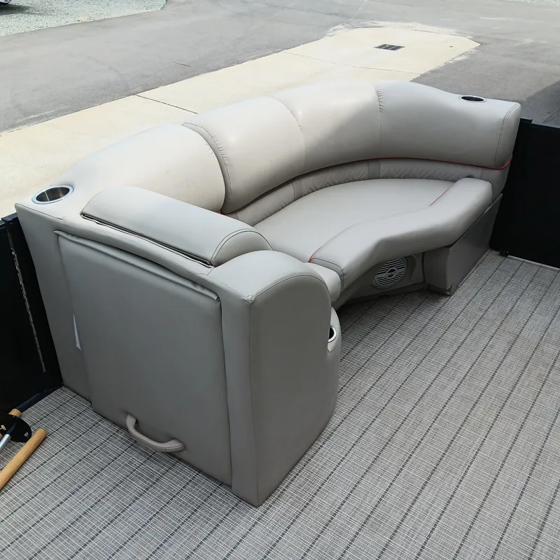 Slide: The Image of 2017 Cypress Cay Seabreeze 213 boat seating with cup holders on a textured deck. - 5