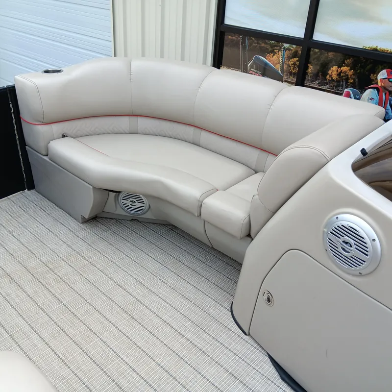 Slide: The Image of 2017 Cypress Cay Seabreeze 213 boat interior with beige seating and built-in speakers. - 7