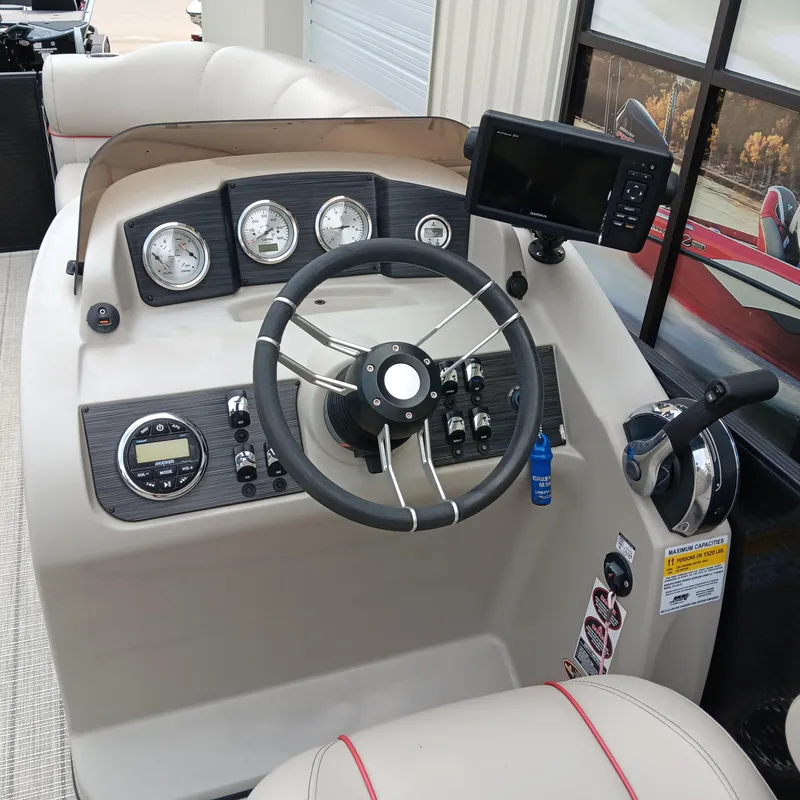 Slide: The Image of 2017 Cypress Cay Seabreeze 213 boat dashboard with steering wheel and gauges. - 8