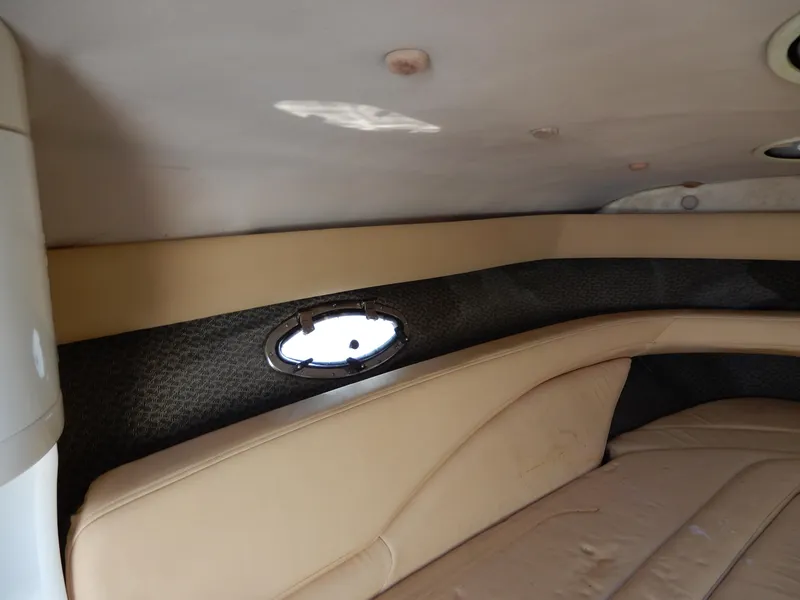 Slide: The Image of Interior cabin of a 2003 Cobalt 293 boat with beige seating and a small window. - 11