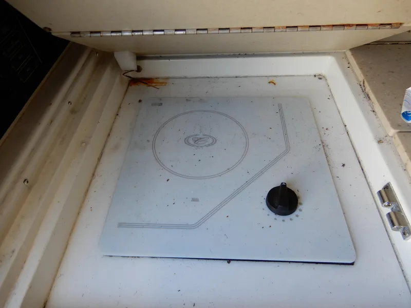 Slide: The Image of 2003 Cobalt 293 boat stove with a single burner and control knob. - 13