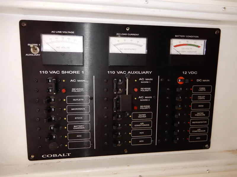 Slide: The Image of Electrical control panel of a 2003 Cobalt 293 boat, showing AC and DC systems. - 14