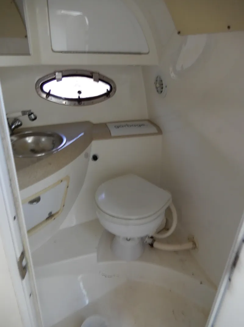 Slide: The Image of Compact bathroom in a 2003 Cobalt 293 boat with sink and toilet. - 16
