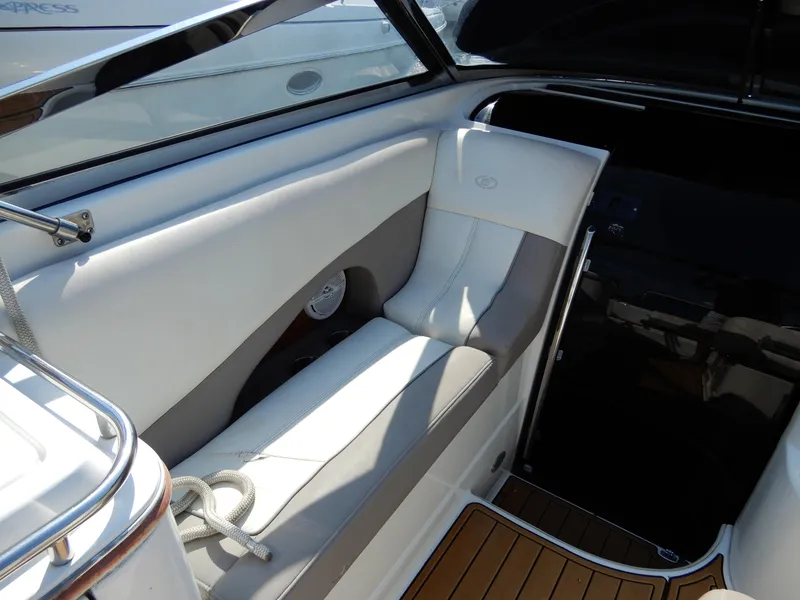 Slide: The Image of Interior of a 2003 Cobalt 293 boat with white seating and wood flooring. - 4