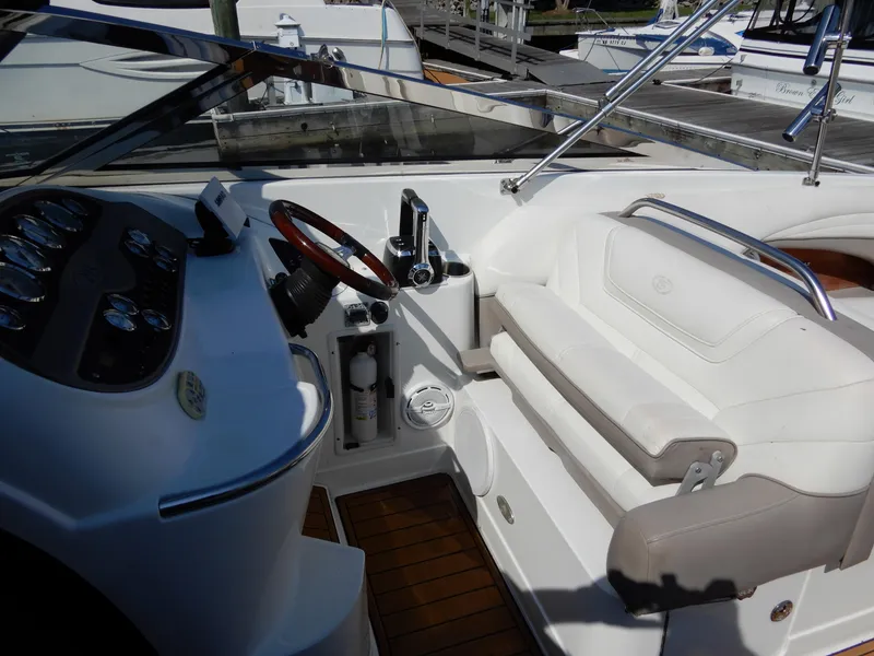 Slide: The Image of Interior of a 2003 Cobalt 293 boat with steering wheel and seating. - 5