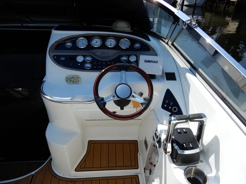 Slide: The Image of 2003 Cobalt 293 boat dashboard with steering wheel and control panel. - 6