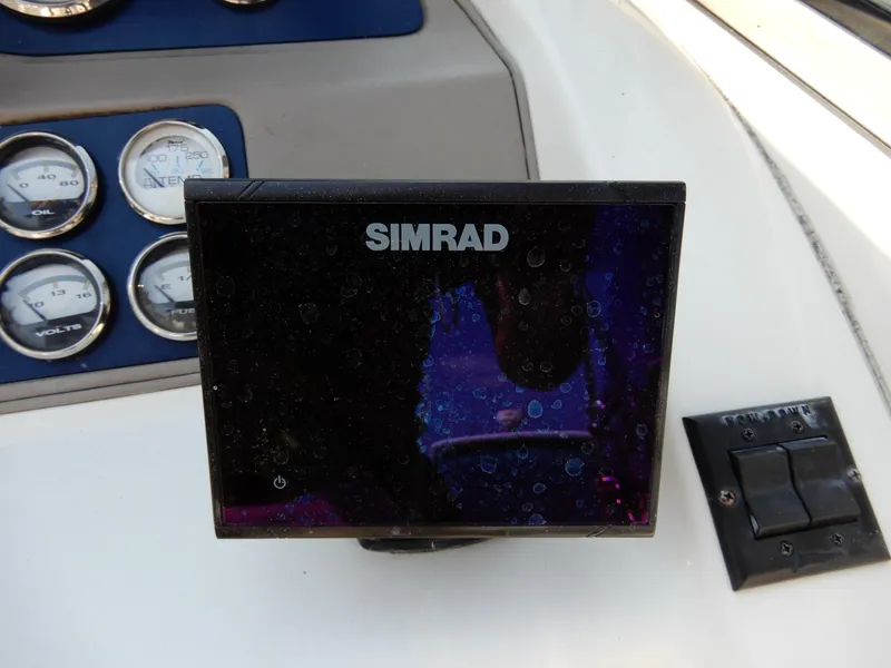 Slide: The Image of Simrad display on 2003 Cobalt 293 boat dashboard with gauges and controls. - 8