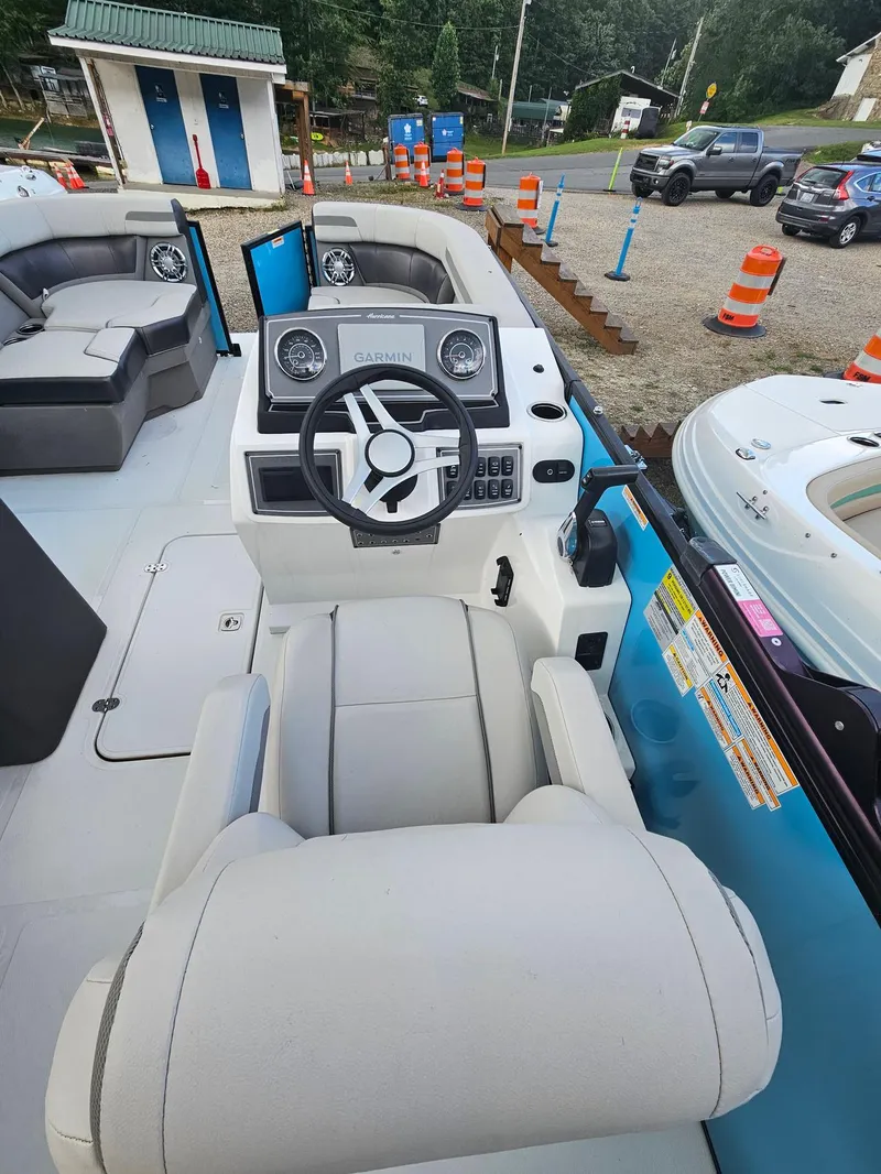 Slide: The Image of 2024 Hurricane FD 1960 RE3 OB boat interior with steering wheel and seating. - 7