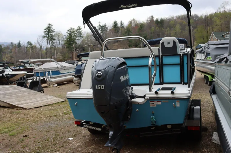 Slide: The Image of 2024 Hurricane FD 1960 RE3 OB boat with Yamaha 150 engine, parked outdoors. - 9