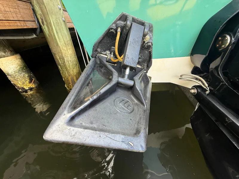 Slide: The Image of Trim tab of a 1988 Wellcraft Scarab 38 KV boat, partially submerged in water. - 14
