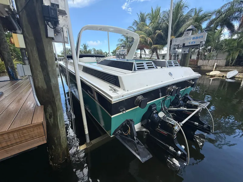 Slide: The Image of 1988 Wellcraft Scarab 38 KV boat docked, featuring dual engines and sleek design. - 15