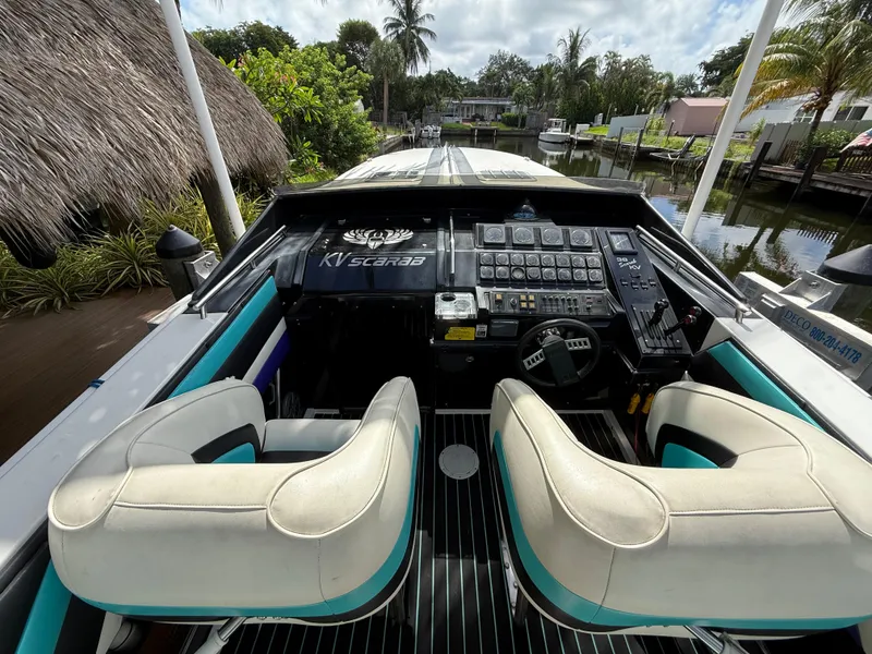 Slide: The Image of 1988 Wellcraft Scarab 38 KV boat cockpit with dual seats and control panel. - 24