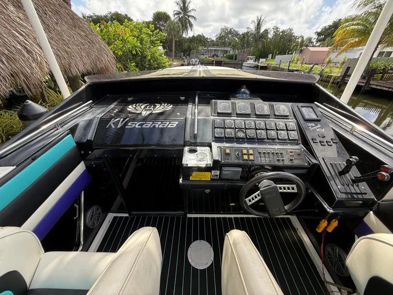 Slide: The Image of 1988 Wellcraft Scarab 38 KV boat cockpit with steering wheel and control panel. - 25