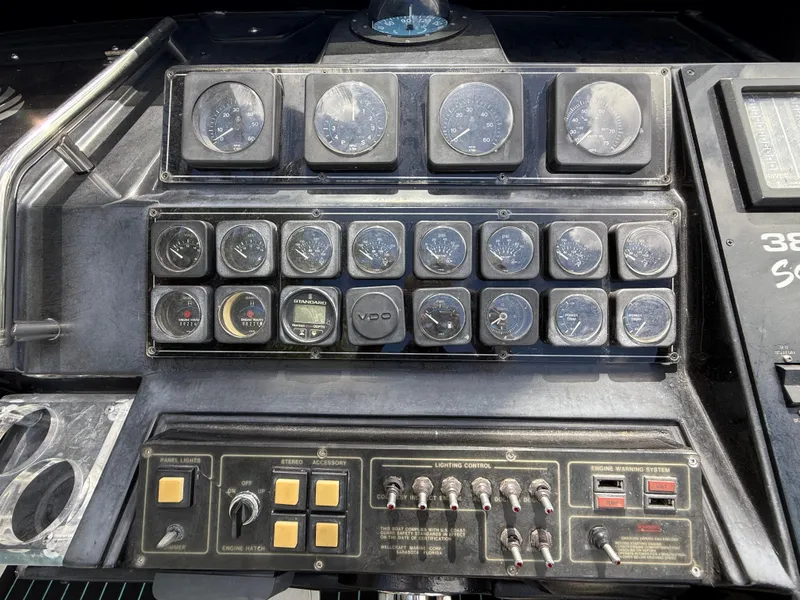 Slide: The Image of 1988 Wellcraft Scarab 38 KV dashboard with gauges and controls. - 27