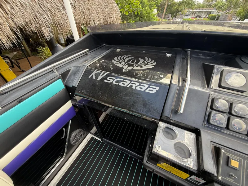 Slide: The Image of 1988 Wellcraft Scarab 38 KV boat dashboard with colorful seating and control panel. - 30