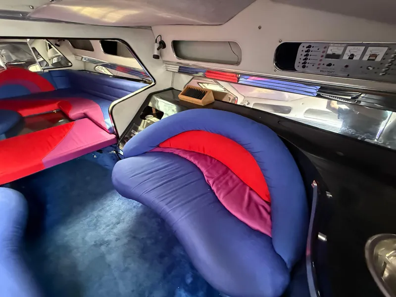 Slide: The Image of Interior of 1988 Wellcraft Scarab 38 KV with vibrant red and blue seating. - 32
