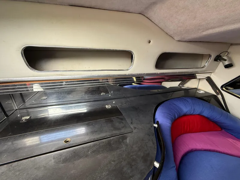 Slide: The Image of Interior of 1988 Wellcraft Scarab 38 KV with colorful seating and storage compartments. - 33