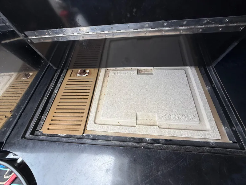 Slide: The Image of Engine compartment of 1988 Wellcraft Scarab 38 KV boat, featuring a closed hatch. - 35