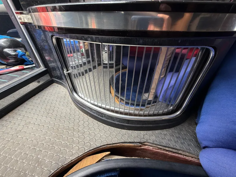 Slide: The Image of 1988 Wellcraft Scarab 38 KV interior with metal grille and blue seating. - 36