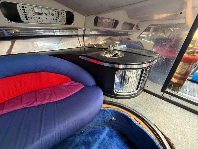 Slide: The Image of Interior of 1988 Wellcraft Scarab 38 KV boat with colorful seating and control panel. - 38